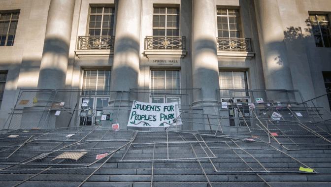 Fences piled on Sproul Hall with banner 